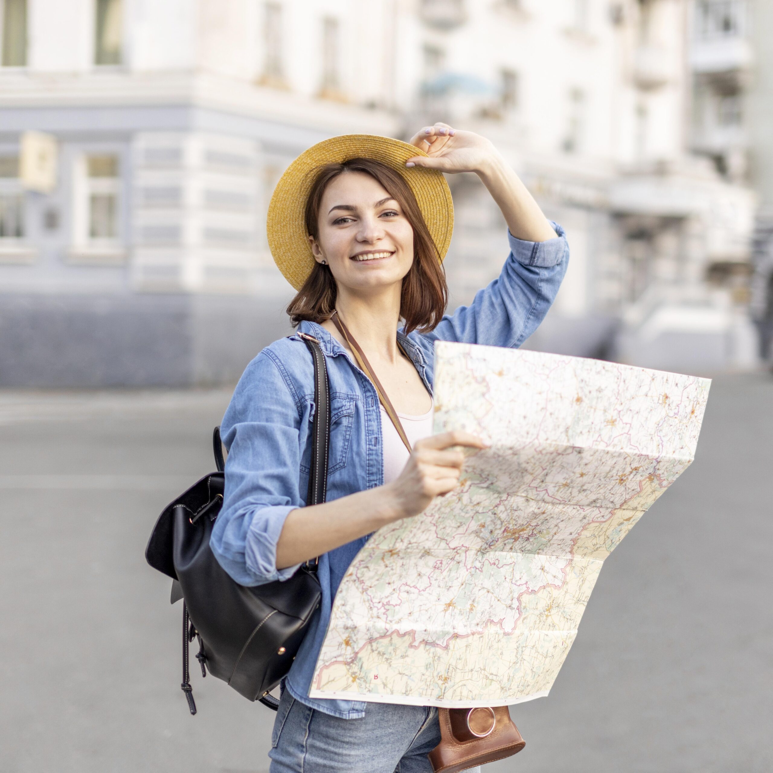 stylish-woman-with-hat-holding-local-map